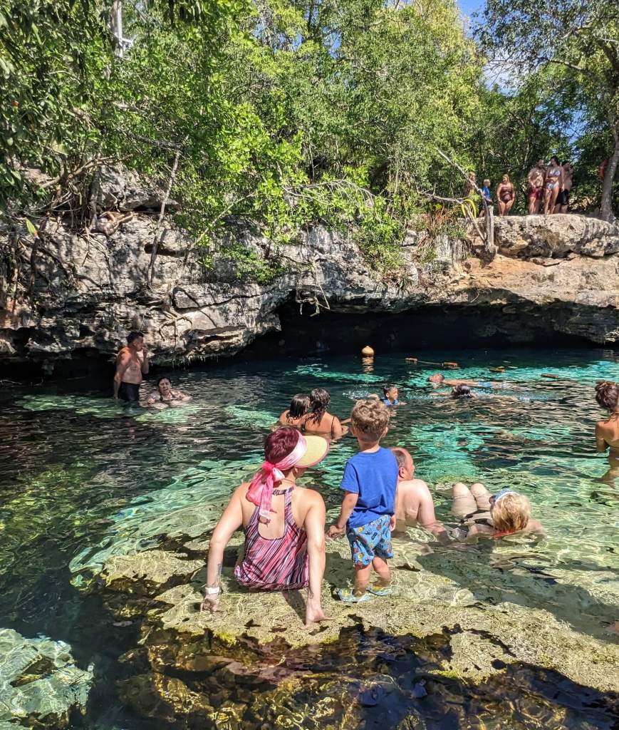My son and me, sitting in Cenote Azul