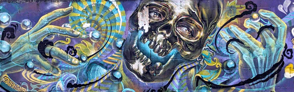 Street art mural featuring skull in Playa del Carmen