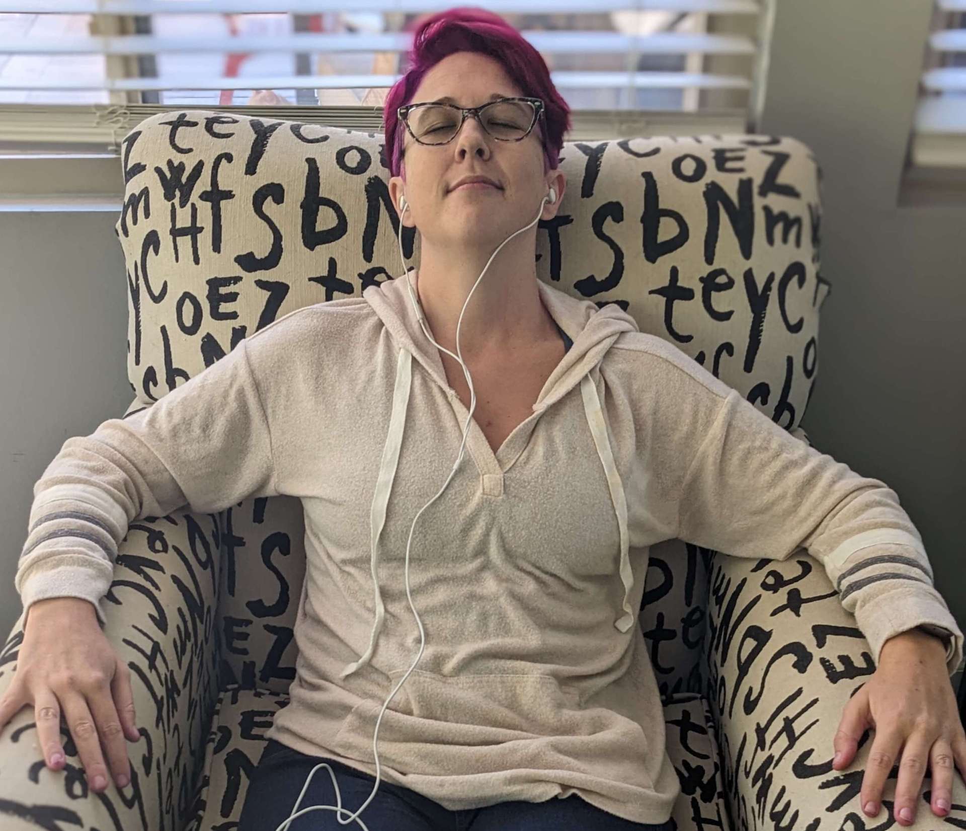 Ashley Schwartau relaxing in her chair listening to her anti-anxiety feel good playlist.