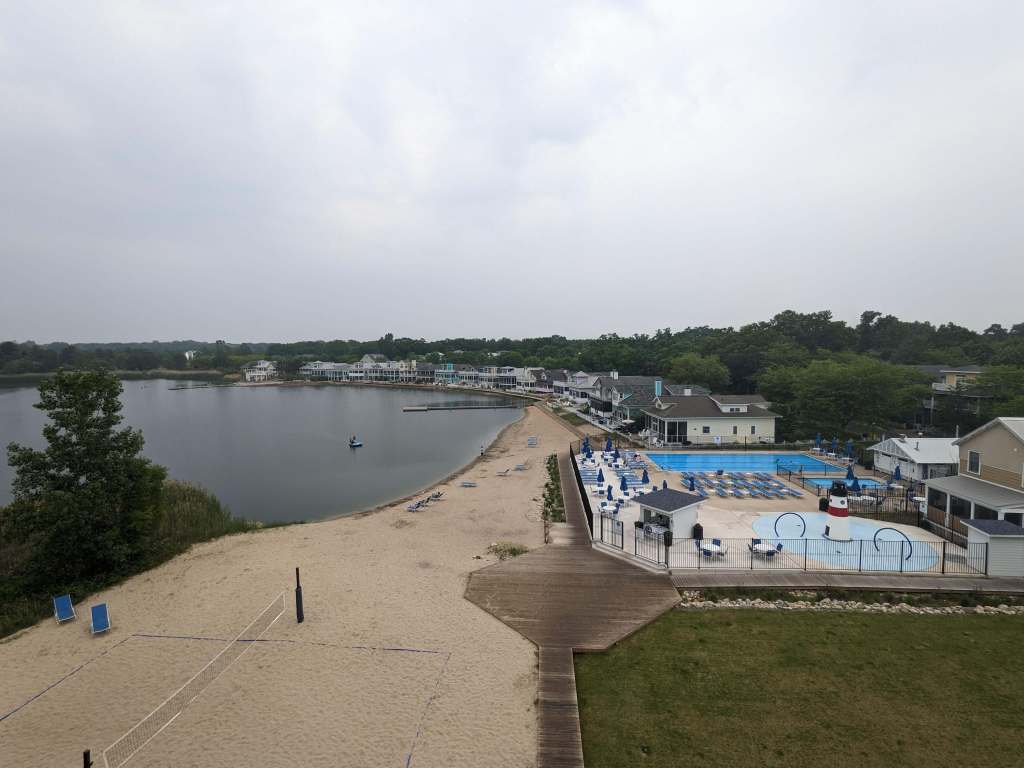 The view from the Beachwalk Clubhouse: a splashpad, a pool, and plenty of places to lounge by Lake Kai